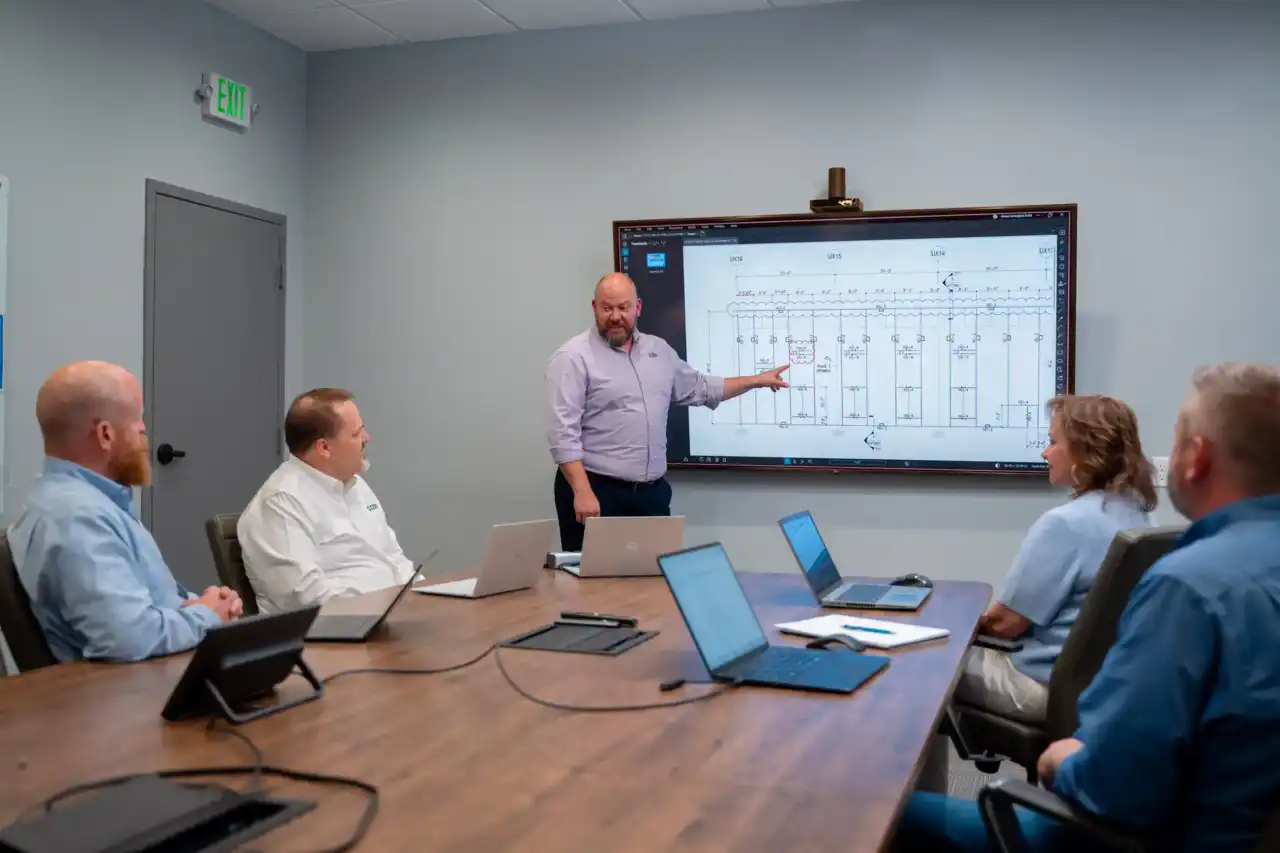 Project team reviewing technical drawings